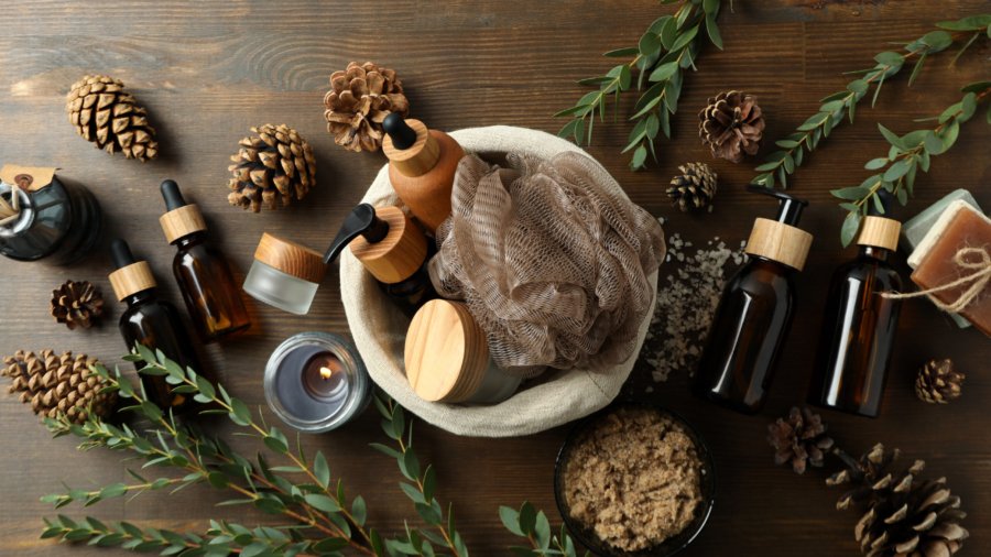 Concept of gift with basket of cosmetics on wooden background