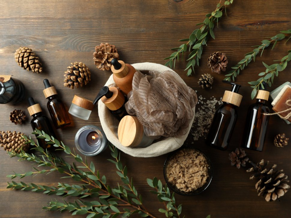 Concept of gift with basket of cosmetics on wooden background